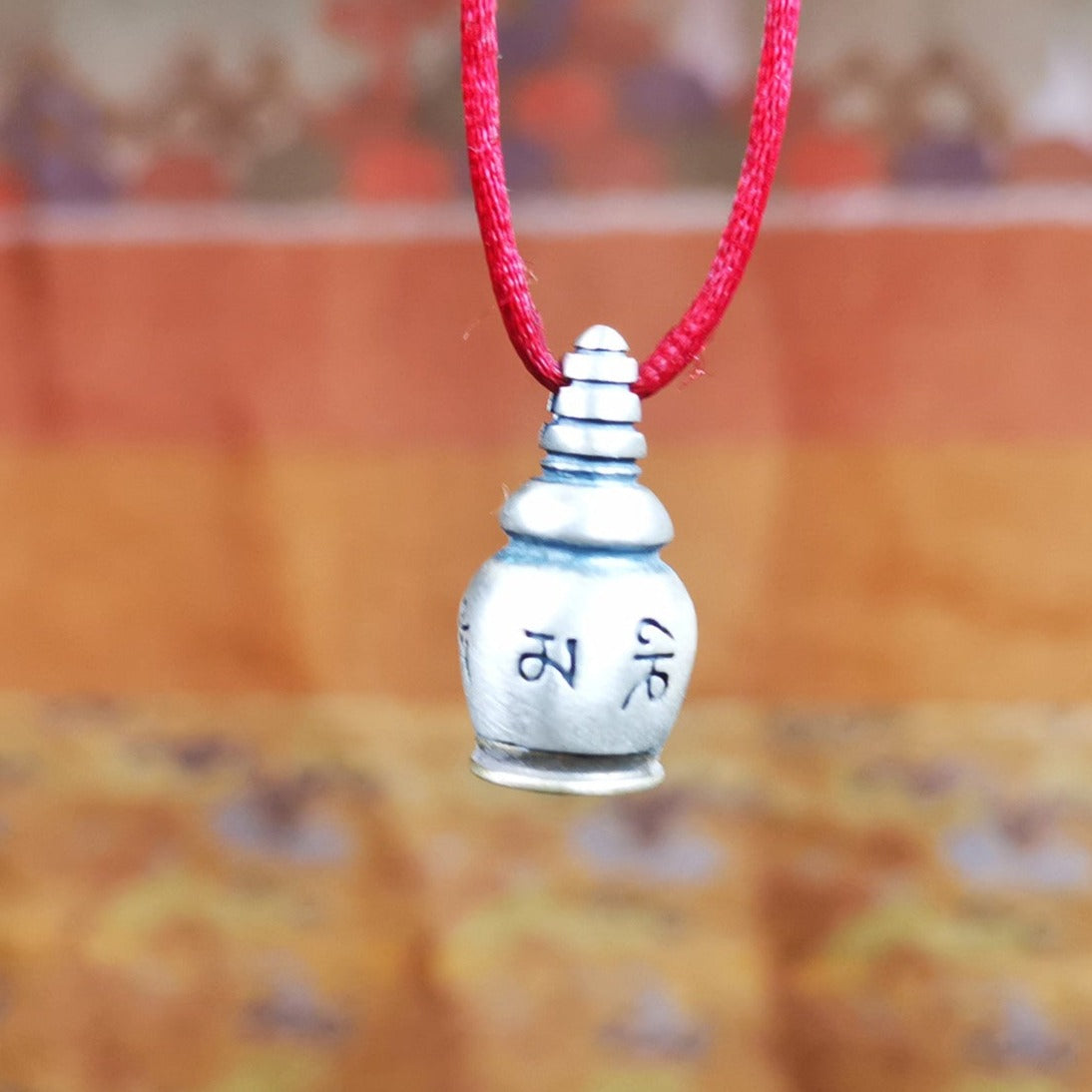 This beautiful stupa gau shrine was handmade by Tibetan craftsmen from Tibet in 2000s. It was made of silver and brass,the OM MANI PADME HUM mantra engraved on its side, the top bottle cap can be opened and you can place offerings inside,like mani rilbu or zung Consecration. The om mantra at the bottom can be used as a seal. You can make it into a necklace, or a keychain, or just put it in your shrine or altar.