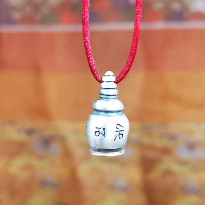 This beautiful stupa gau shrine was handmade by Tibetan craftsmen from Tibet in 2000s. It was made of silver and brass,the OM MANI PADME HUM mantra engraved on its side, the top bottle cap can be opened and you can place offerings inside,like mani rilbu or zung Consecration. The om mantra at the bottom can be used as a seal. You can make it into a necklace, or a keychain, or just put it in your shrine or altar.