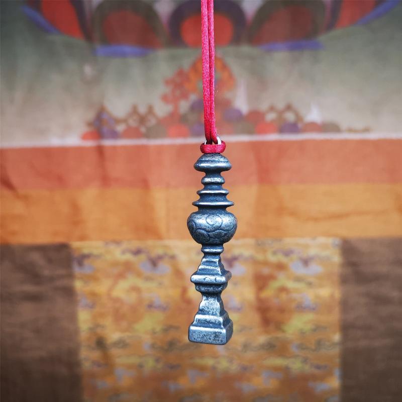 This beautiful stupa pendant is hand carved by Tibetan craftsmen from Tibet in 1990's. From Hepo Town, Baiyu County, the birthplace of the famous Tibetan handicrafts. It was made of cold iron,inlaid copper dot,2.16 inches height,0.51 inch width. You can make it a pendant, or put it in your shrine.