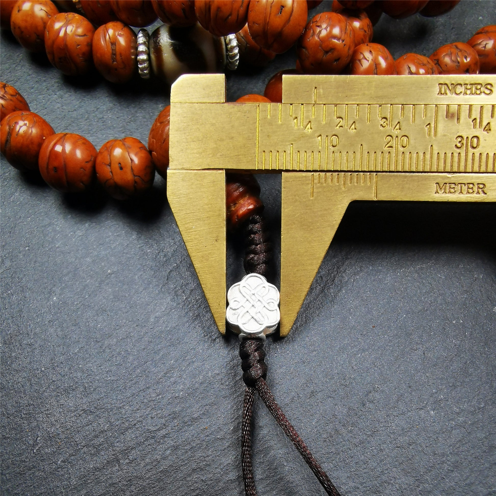This old bodhi seed beads mala was collected from Derge county,hold and blessed by a lama in Gengqing monastery, about 30 years old.  It is composed of 108 bodhi seed beads, and is equipped with 3 dzi beads, silver spacer beads, bead counters and maini jewel clip,and finally consists a lucky knot bead on the end, very elegant.