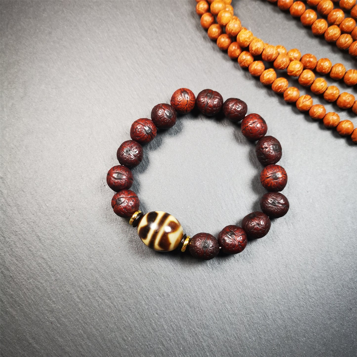 This unique Dalo Dzi bracelet combines the mysterious and unique qualities of the tiger tooth dalo dzi and 15 old bodhi seed beads,giving it a distinct feel.  It is brown in color and has a circumference of approximately 7 inches, suitable for most wrist sizes. 