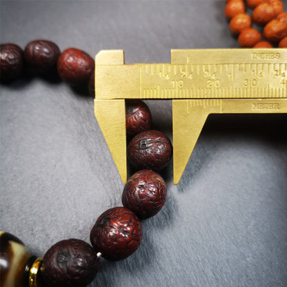 This unique Dalo Dzi bracelet combines the mysterious and unique qualities of the tiger tooth dalo dzi and 15 old bodhi seed beads,giving it a distinct feel.  It is brown in color and has a circumference of approximately 7 inches, suitable for most wrist sizes. 