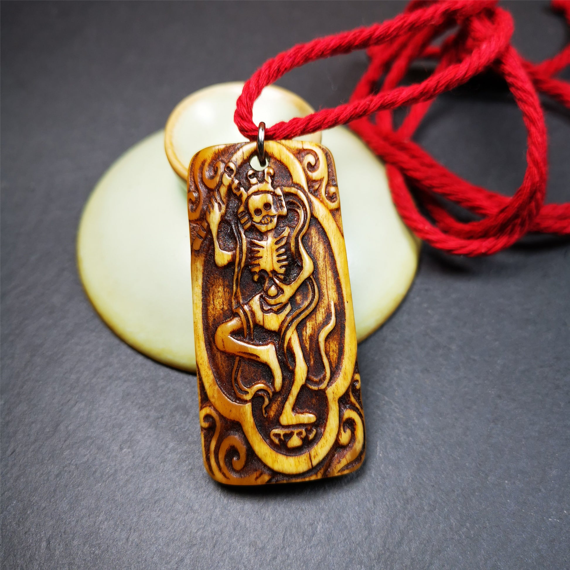 This beautiful bone carved Chitipati skull amulet is hand carved by Tibetan craftsmen . It is Masters of Sitavana, entirely hand-carved of yak bone,wears a crown with 3 skulls,size is 2.3 inches