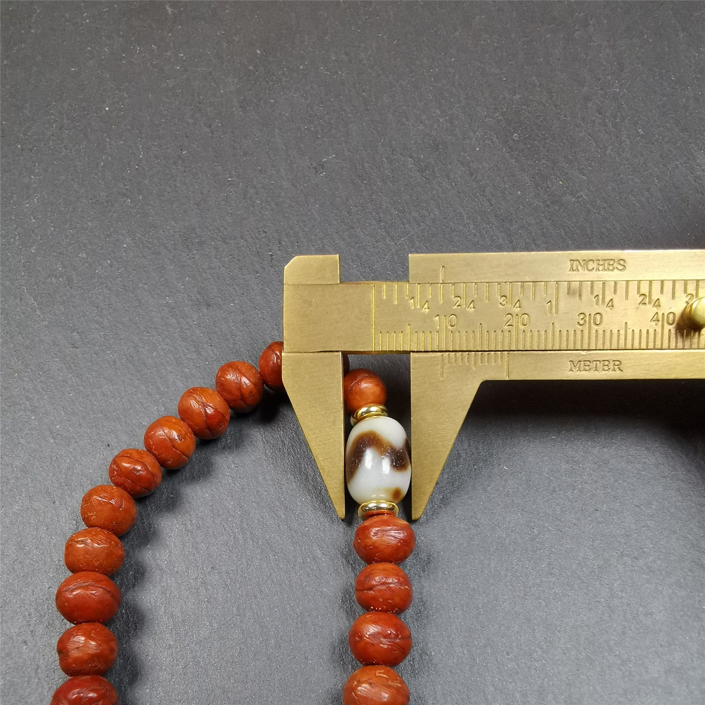 This bodhi beads mala is made by Tibetan craftsmen and come from Hepo Town, Baiyu County, the birthplace of the famous Tibetan handicrafts,about 30 years old, hold and blessed by a lama in Baiyu Monastery.  It is composed of 108 bodhi seed beads, and is equipped with 3 dzi beads, silver bead counters are installed on both sides, 1 mantra dots bead clip,and finally consists a silver vajra on the end, very elegant.