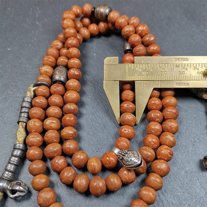 This bodhi beads mala is made by Tibetan craftsmen and come from Hepo Town, Baiyu County, the birthplace of the famous Tibetan handicrafts,about 30 years old, hold and blessed by a lama in Baiyu Monastery.  It is composed of 108 bodhi seed beads, and is equipped with 3 cold iron dzi beads, cold iron bead counters are installed on both sides, 1 mani jewel bead clip,and finally consists a skull guru bead and vajra on the end, very elegant.