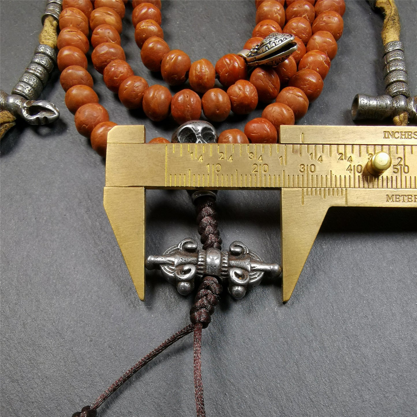 This bodhi beads mala is made by Tibetan craftsmen and come from Hepo Town, Baiyu County, the birthplace of the famous Tibetan handicrafts,about 30 years old, hold and blessed by a lama in Baiyu Monastery.  It is composed of 108 bodhi seed beads, and is equipped with 3 cold iron dzi beads, cold iron bead counters are installed on both sides, 1 mani jewel bead clip,and finally consists a skull guru bead and vajra on the end, very elegant.