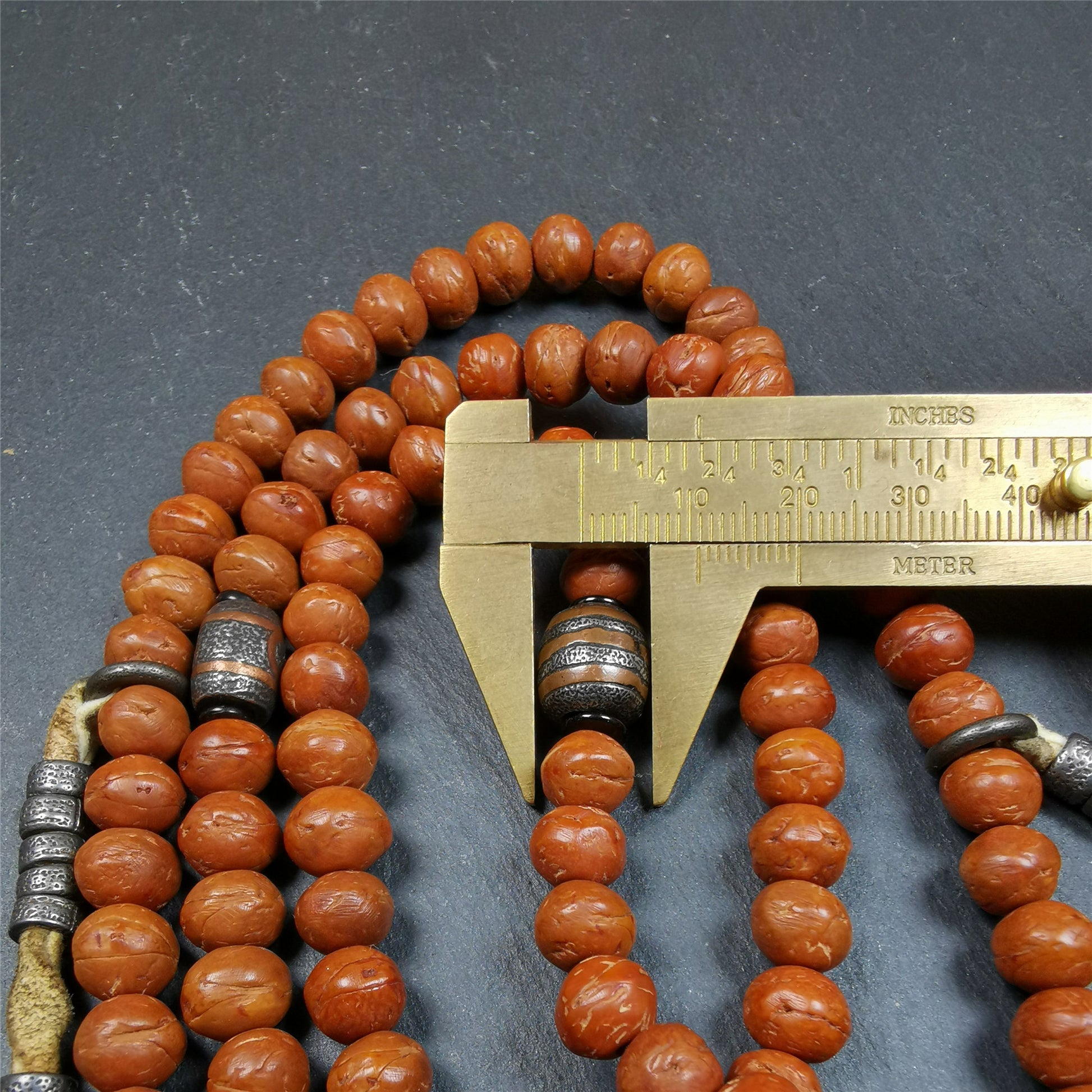 This bodhi beads mala is made by Tibetan craftsmen and come from Hepo Town, Baiyu County, the birthplace of the famous Tibetan handicrafts,about 30 years old, hold and blessed by a lama in Baiyu Monastery.  It is composed of 108 bodhi seed beads, and is equipped with 3 cold iron dzi beads, cold iron bead counters are installed on both sides, 1 mani jewel bead clip,and finally consists a skull guru bead and vajra on the end, very elegant.