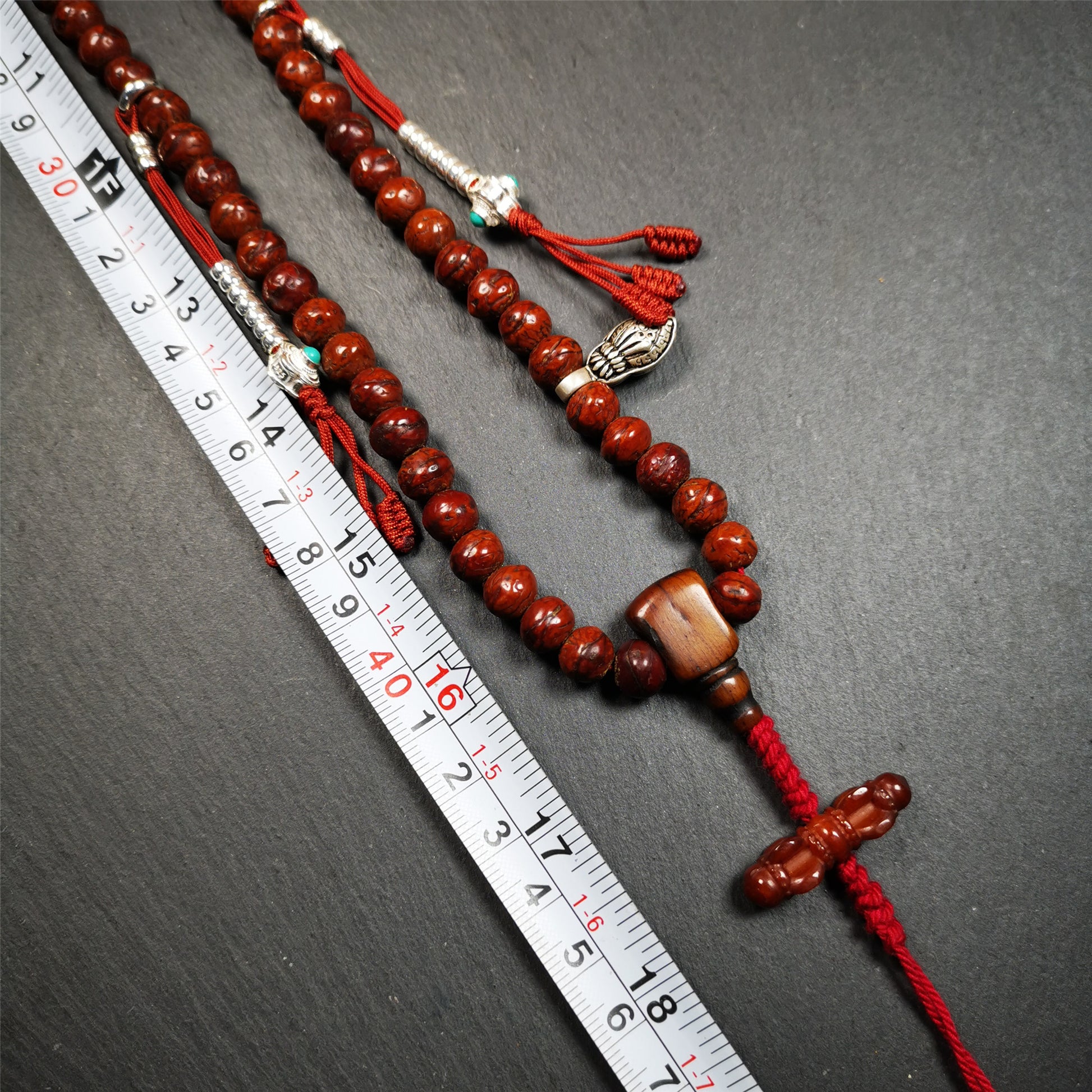 This bodhi beads mala is made by Tibetan craftsmen and come from Hepo Town, Baiyu County, the birthplace of the famous Tibetan handicrafts,about 30 years old, hold and blessed by a lama in Baiyu Monastery. It is composed of 108 bodhi seed beads, and is equipped with 3 agate beads, silver bead counters are installed on both sides, 1 mani jewel bead clip,and finally consists a bone guru bead and vajra on the end, very elegant.