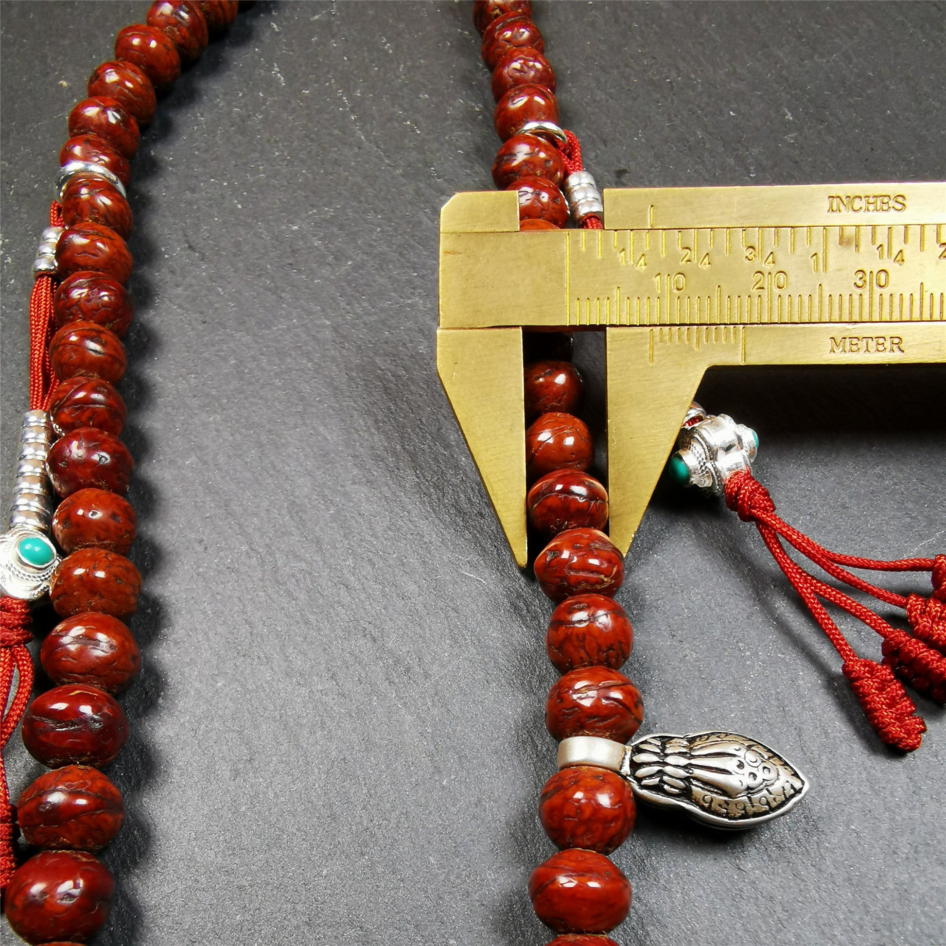 This bodhi beads mala is made by Tibetan craftsmen and come from Hepo Town, Baiyu County, the birthplace of the famous Tibetan handicrafts,about 30 years old, hold and blessed by a lama in Baiyu Monastery. It is composed of 108 bodhi seed beads, and is equipped with 3 agate beads, silver bead counters are installed on both sides, 1 mani jewel bead clip,and finally consists a bone guru bead and vajra on the end, very elegant.