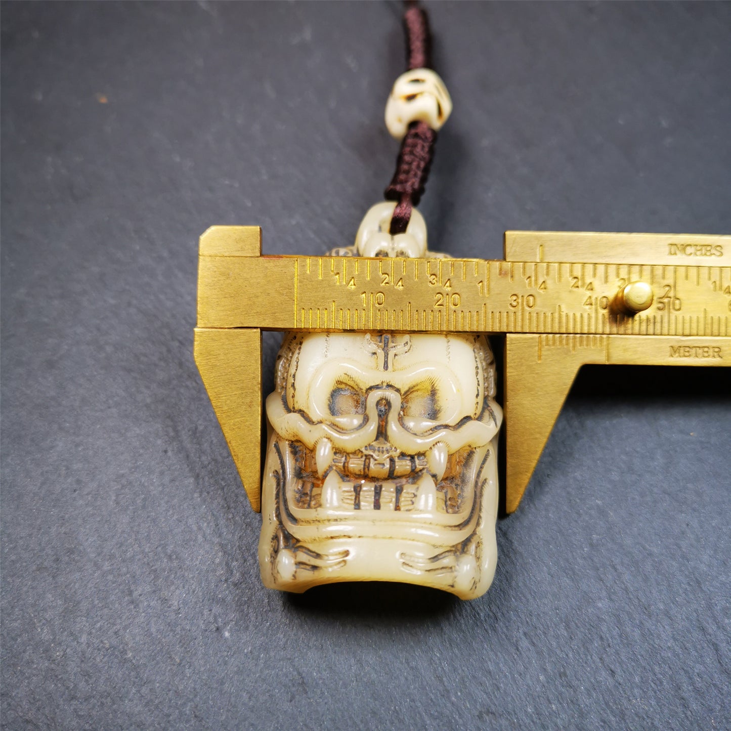 This beautiful bone skull amulet is hand carved by Tibetan craftsmen from Hepo Town, Baiyu County, the birthplace of the famous Tibetan handicrafts. It is Masters of Sitavana, entirely hand-carved of yak bone,wears a crown with 5 skulls,size is 2.3 inches,very beautiful. You can use it as a pendant, or bag hanging,or put it into your shrin