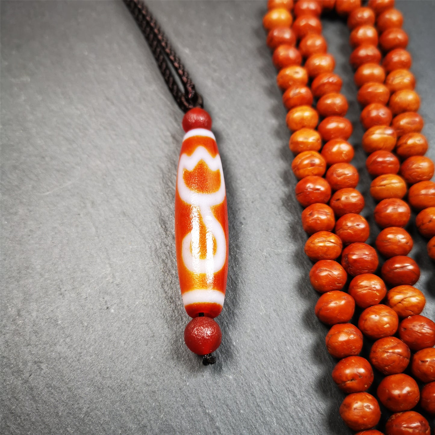 This vintage Lotus Dzi Bead is made of fire agate,new but high quality,size is 1.9" × 0.5". The lotus is the symbol of what is divine or immortal in humanity, and is also a symbol of divine perfection. The lotus is the attribute of sun and fire gods.