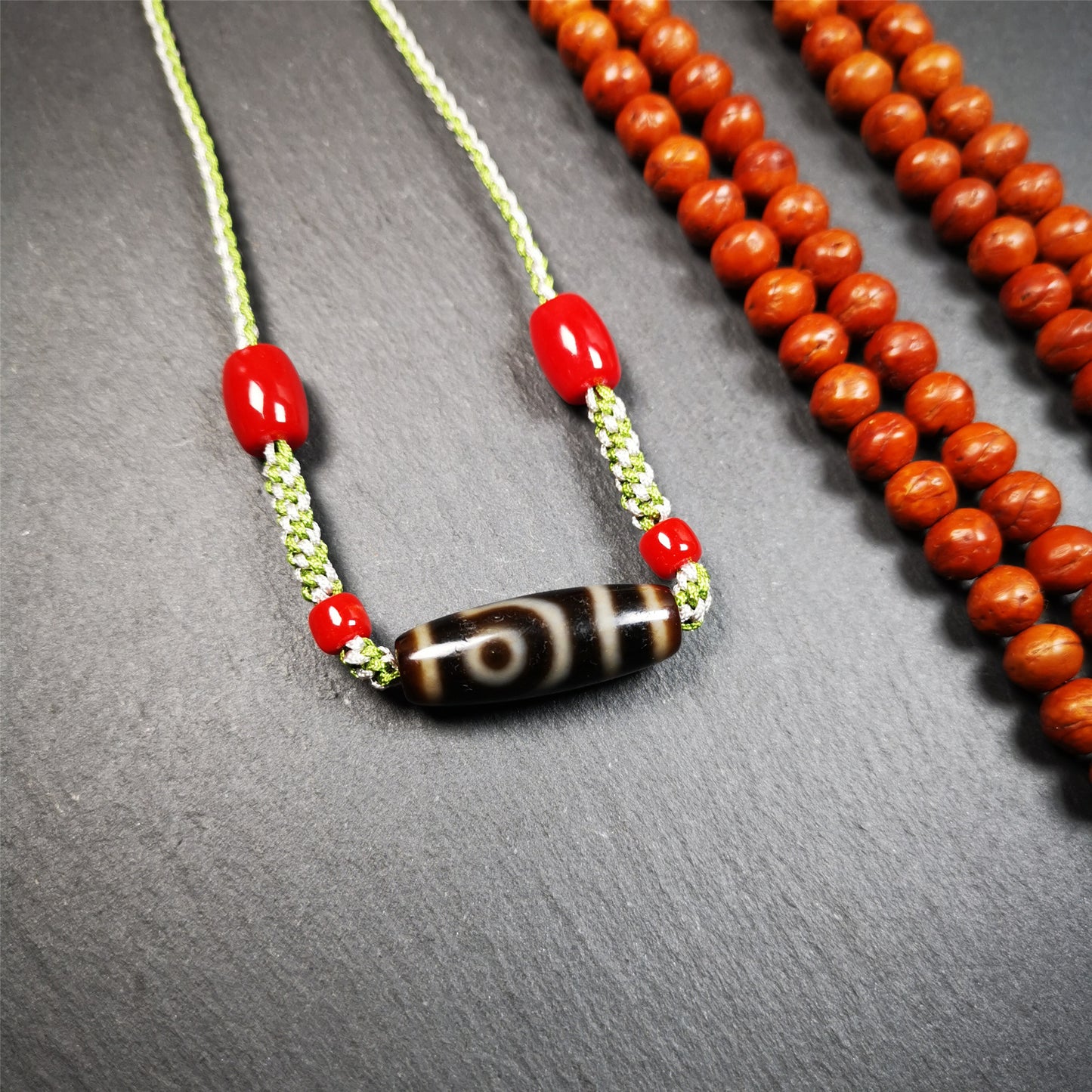 This necklace was hand-woven by Tibetans from Baiyu County, the main bead is a 2 eyed dzi bead, paired with agate beads,about 30 years old. It can be worn as a fashionable accessory, also holds cultural and religious significance.