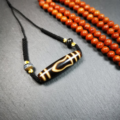 This necklace was hand-woven by Tibetans from Baiyu County, the main bead is a mountain eye dzi bead, paired with 2 small stripe dzi beads,about 30 years old. It can be worn not only as a fashionable accessory but also holds cultural and religious significance.