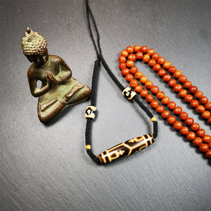 This necklace was hand-woven by Tibetans from Baiyu County, the main bead is a treasure vase dzi bead, paired with 3 eyed dzi beads,about 30 years old. It can be worn as a fashionable accessory, also holds cultural and religious significance.