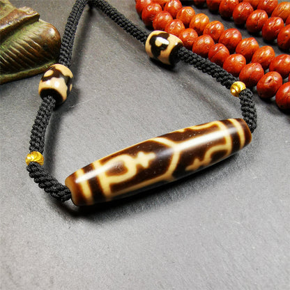 This necklace was hand-woven by Tibetans from Baiyu County, the main bead is a treasure vase dzi bead, paired with 3 eyed dzi beads,about 30 years old. It can be worn as a fashionable accessory, also holds cultural and religious significance.