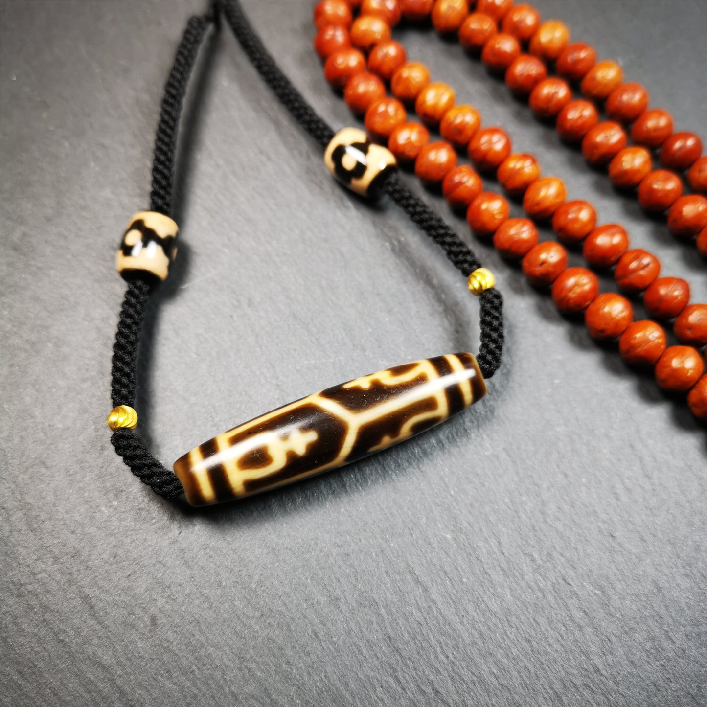 This necklace was hand-woven by Tibetans from Baiyu County, the main bead is a treasure vase dzi bead, paired with 3 eyed dzi beads,about 30 years old. It can be worn as a fashionable accessory, also holds cultural and religious significance.