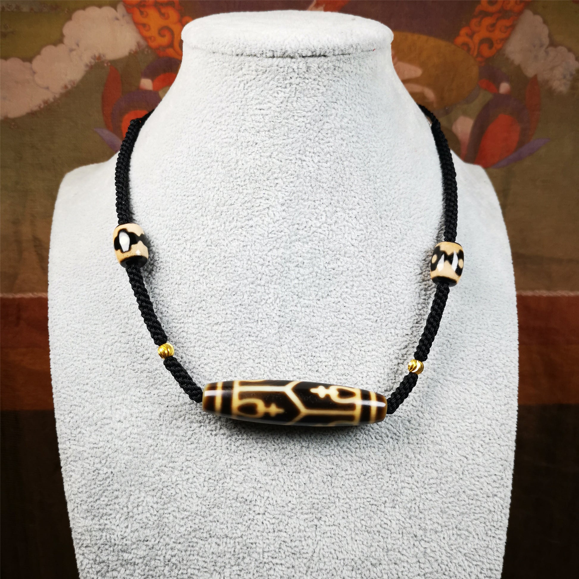 This necklace was hand-woven by Tibetans from Baiyu County, the main bead is a treasure vase dzi bead, paired with 3 eyed dzi beads,about 30 years old. It can be worn as a fashionable accessory, also holds cultural and religious significance.