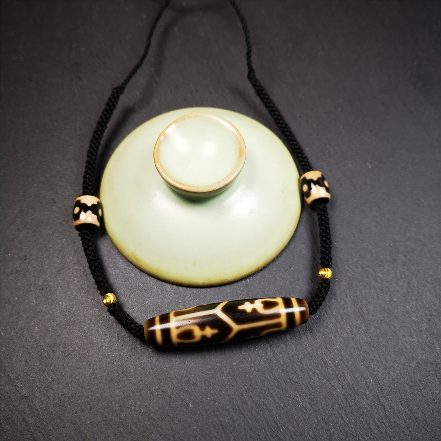 This necklace was hand-woven by Tibetans from Baiyu County, the main bead is a treasure vase dzi bead, paired with 3 eyed dzi beads,about 30 years old. It can be worn as a fashionable accessory, also holds cultural and religious significance.