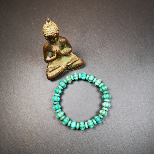 This beautiful turquoise bracelet is handmade from Tibet in 1980's. It's green color, made of turquoise, 19 hexagon beads and 19 spacer beads in total,7.4 inches circumference,0.47 width.