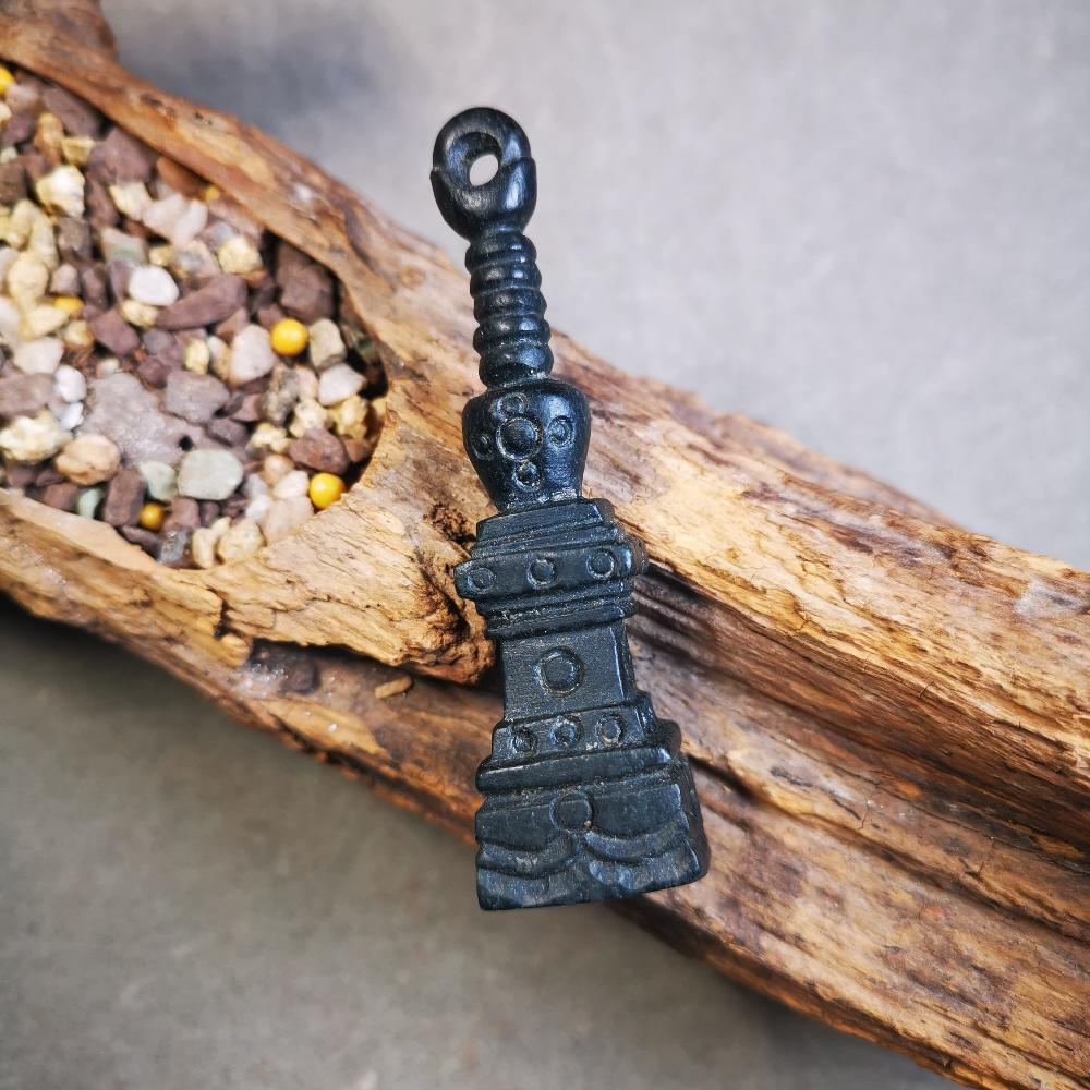 This beautiful stupa pendant is hand carved by Tibetan craftsmen from Tibet in 2000's. From Hepo Town, Baiyu County, the birthplace of the famous Tibetan handicrafts. It was made of obsidian, all black color,2.95 inches height. At the bottom of it is engraved with the Tibetan word OM.