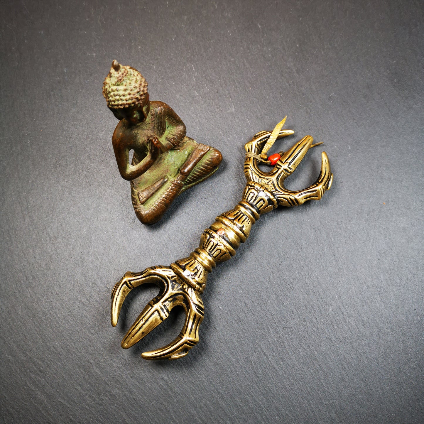 This unique vajra pendant was handmade by Tibetan craftsmen from Tibet in 2000's,from Hepo Town, Baiyu County, the birthplace of the famous Tibetan handicrafts. It is unique flat three - pronged Vajra,made of brass, yellow color,6.3 inches length. In tantric Buddhist practice, the vajra is a potent instrument with multifaceted meaning, symbolizing the adamantine state of existence of a Buddhist practitioner who has reached full enlightenment. The vajra is the archetypal symbol of tantric Buddhism.