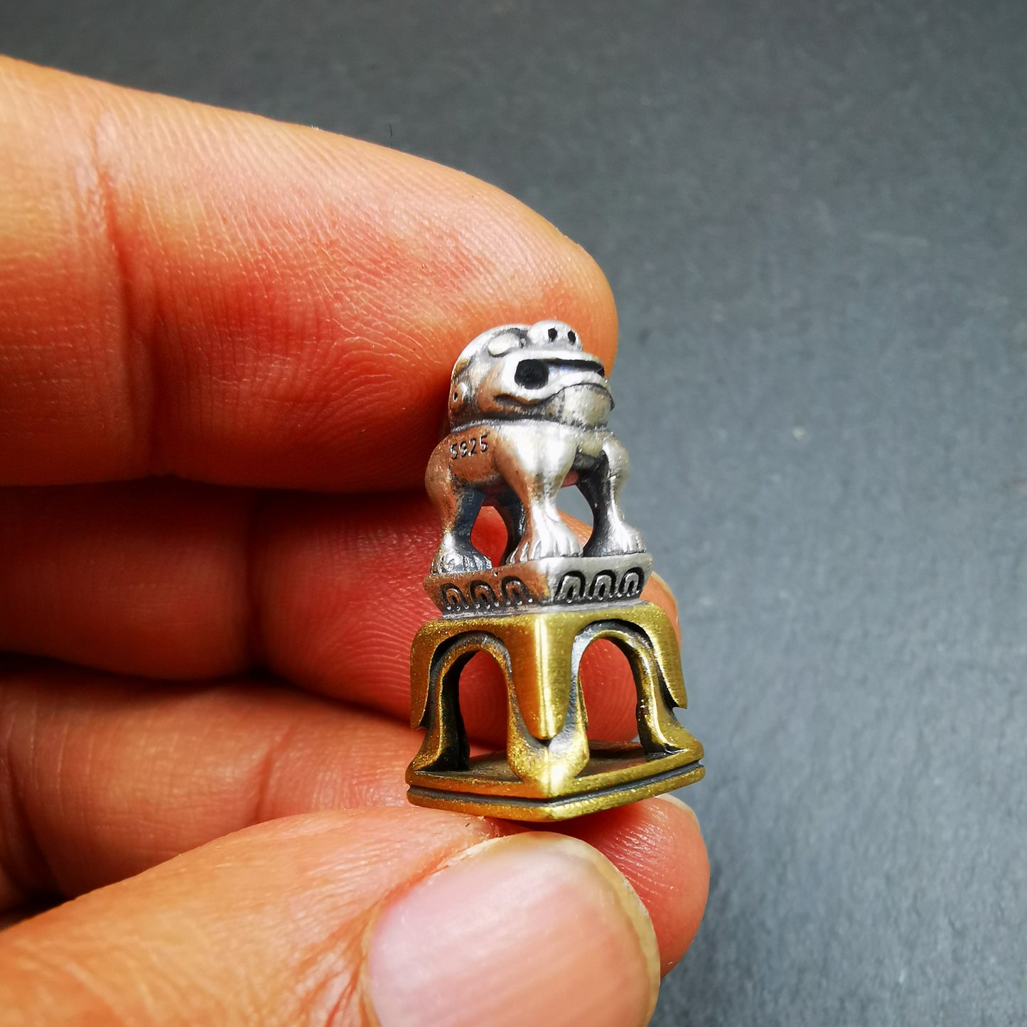 This tibetan snow lion seal was handmade from tibetan craftman. It is made of silver and brass,carved snow lion on the top and the Swastika symbol seal on the bottom,size is 0.9 inches.