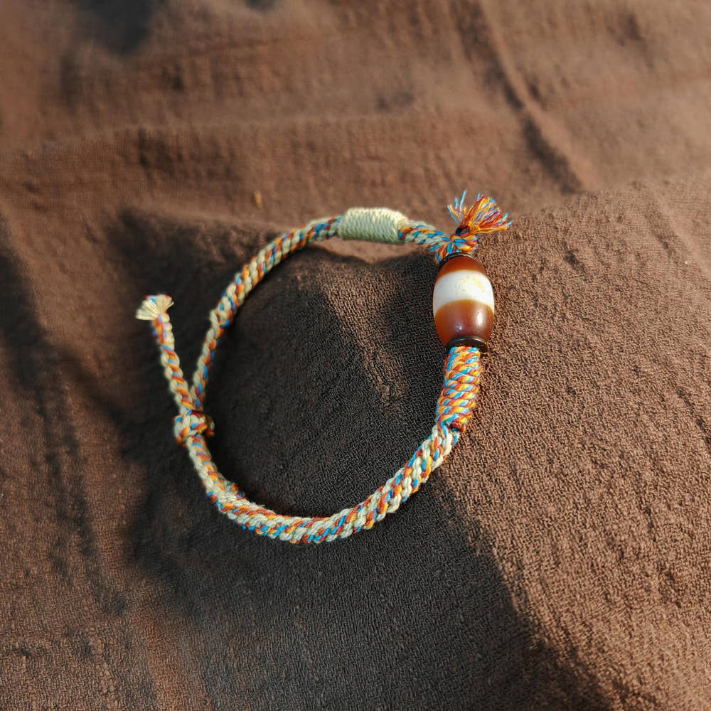 Hand Woven Bracelet with Fire Agate Tibetan Stripe Dzi Beads - Tibetan dzi bead, front view