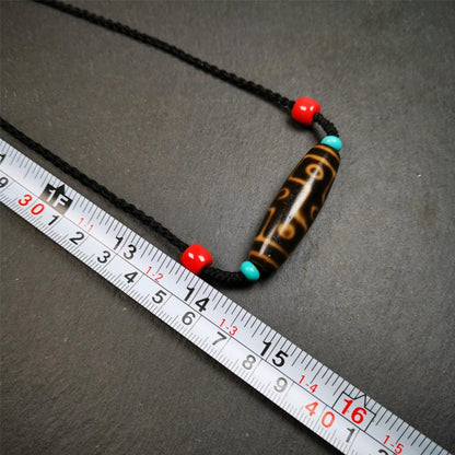 This 9 eyes dzi bead was collected from gerze Tibet,about 50 years old. The necklace was hand-woven by Tibetans from Baiyu County, the main bead is a brown color 9 eyes dzi, paired with 2 turquoise beads and 2 red agate beads.