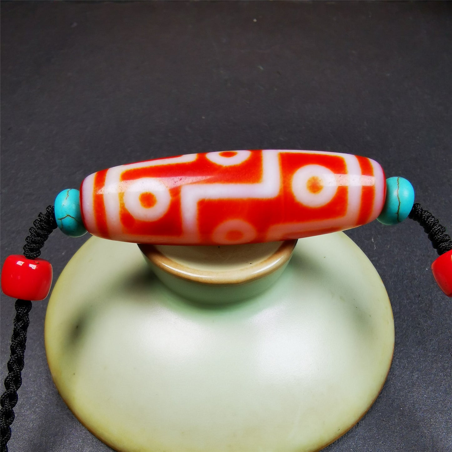 This necklace was hand-woven by Tibetans from Baiyu County, the main bead is a fire agate 9 eyes dzi, paired with 2 turquoise beads and 2 red agate beads,about 30 years old. The length of the necklace can be adjusted.