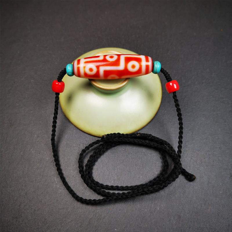 This necklace was hand-woven by Tibetans from Baiyu County, the main bead is a fire agate 9 eyes dzi, paired with 2 turquoise beads and 2 red agate beads,about 30 years old. The length of the necklace can be adjusted.