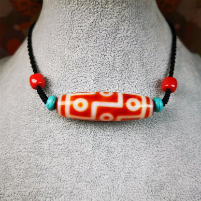 This necklace was hand-woven by Tibetans from Baiyu County, the main bead is a fire agate 9 eyes dzi, paired with 2 turquoise beads and 2 red agate beads,about 30 years old. The length of the necklace can be adjusted.