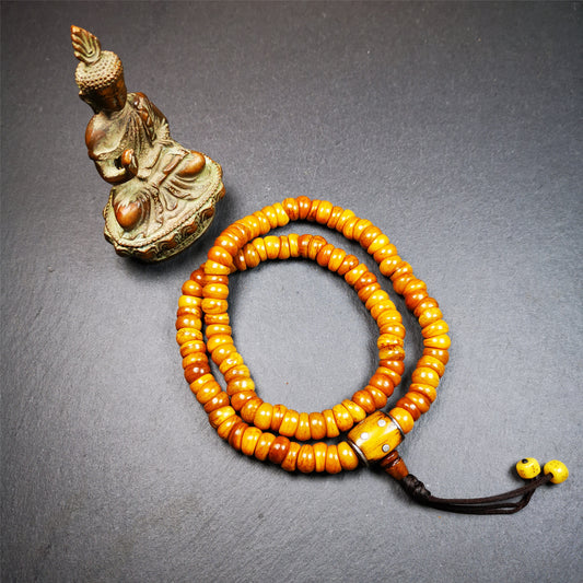 This mala was made by Tibetan craftsmen,about 30 years old.  It is made of yak bone, yellow color,108 bevel cut beads diameter of 10mm / 0.4 inch,circumference is 50cm / 20 inches,1 guru bead and 2 dice pendant beads.