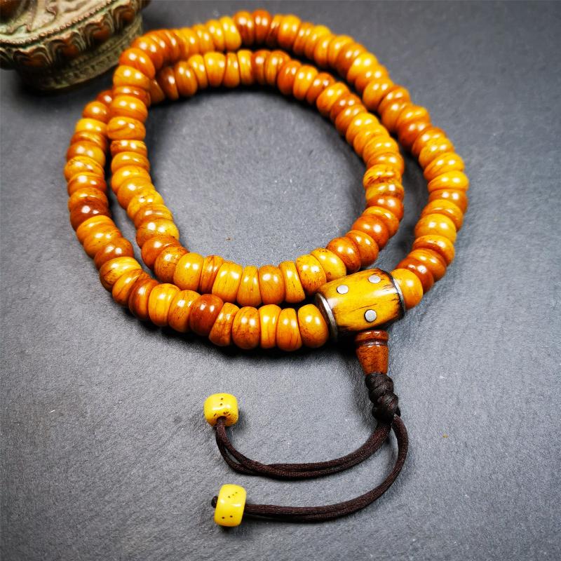 This mala was made by Tibetan craftsmen,about 30 years old.  It is made of yak bone, yellow color,108 bevel cut beads diameter of 10mm / 0.4 inch,circumference is 50cm / 20 inches,1 guru bead and 2 dice pendant beads.