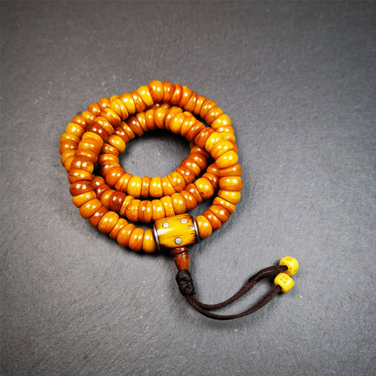 This mala was made by Tibetan craftsmen,about 30 years old.  It is made of yak bone, yellow color,108 bevel cut beads diameter of 10mm / 0.4 inch,circumference is 50cm / 20 inches,1 guru bead and 2 dice pendant beads.
