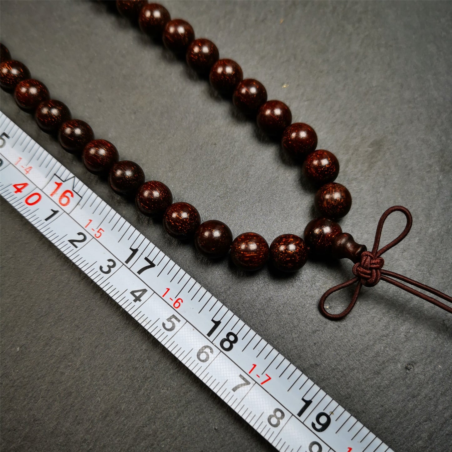 This mala was made by Tibetan craftsmen from Hepo Town, Baiyu County, the birthplace of the famous Tibetan handicrafts.  It is made of Dalbergia Wood(Huanghuali), brown color,108 round cut beads diameter of 9mm / 0.35",circumference is 92cm / 36".