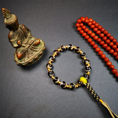 This tiger tooth dzi bracelet was hand-woven by Tibetans from Baiyu County,Tibet. It consists of 15 tiger tooth dzi beads and 15 spacer beads,tie with elastic cord to fit your wrist.  Dzi beads are precious jewelry from Tibetan culture which are believed to possess the power of bringing good fortune to the owners.  You'll get 1 dzi bracelet as pictures shown.