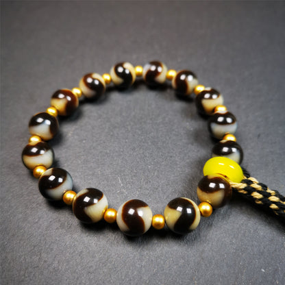 This tiger tooth dzi bracelet was hand-woven by Tibetans from Baiyu County,Tibet. It consists of 15 tiger tooth dzi beads and 15 spacer beads,tie with elastic cord to fit your wrist.  Dzi beads are precious jewelry from Tibetan culture which are believed to possess the power of bringing good fortune to the owners.  You'll get 1 dzi bracelet as pictures shown.