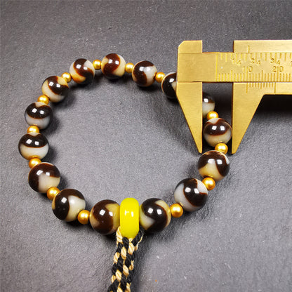 This tiger tooth dzi bracelet was hand-woven by Tibetans from Baiyu County,Tibet. It consists of 15 tiger tooth dzi beads and 15 spacer beads,tie with elastic cord to fit your wrist.  Dzi beads are precious jewelry from Tibetan culture which are believed to possess the power of bringing good fortune to the owners.  You'll get 1 dzi bracelet as pictures shown.