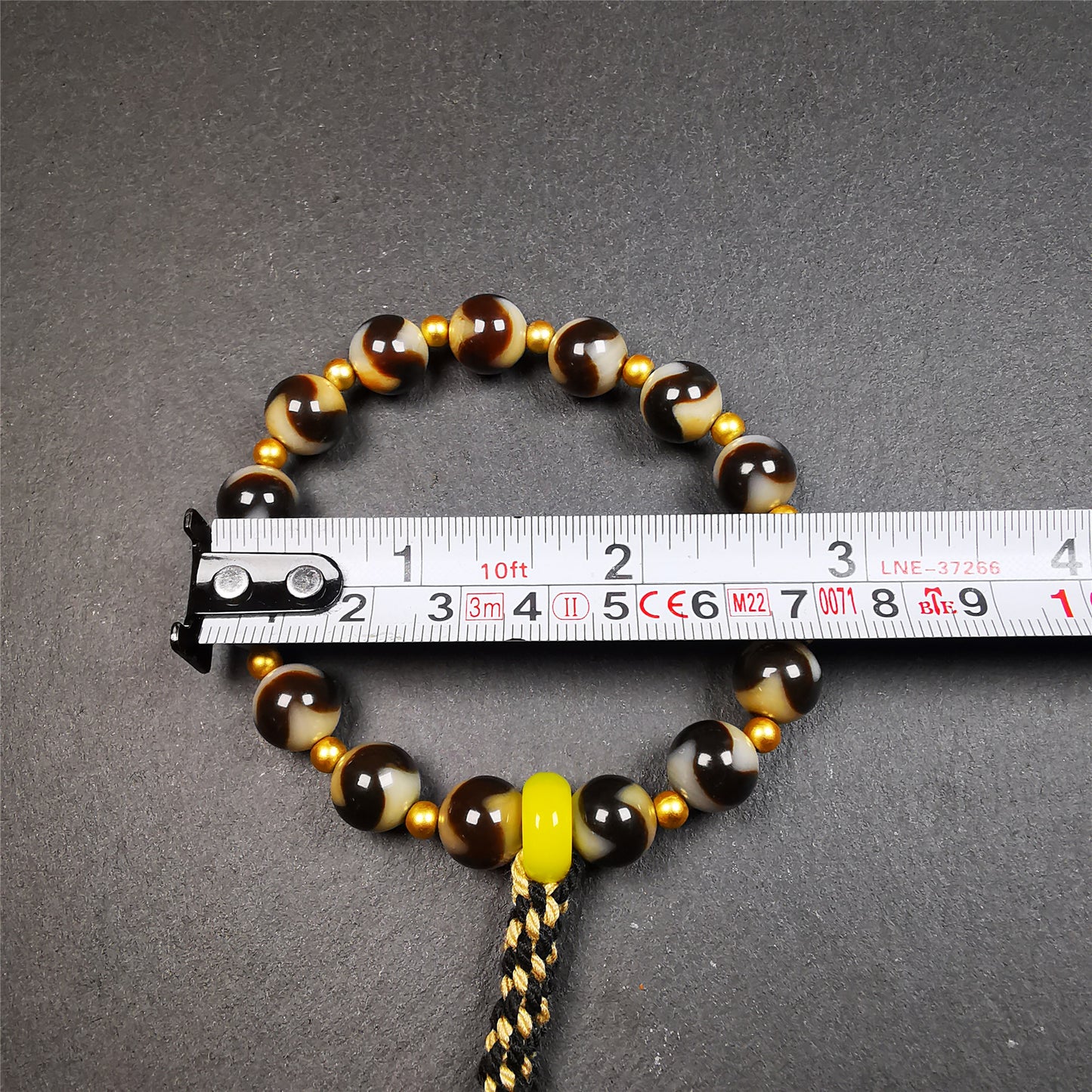 This tiger tooth dzi bracelet was hand-woven by Tibetans from Baiyu County,Tibet. It consists of 15 tiger tooth dzi beads and 15 spacer beads,tie with elastic cord to fit your wrist.  Dzi beads are precious jewelry from Tibetan culture which are believed to possess the power of bringing good fortune to the owners.  You'll get 1 dzi bracelet as pictures shown.