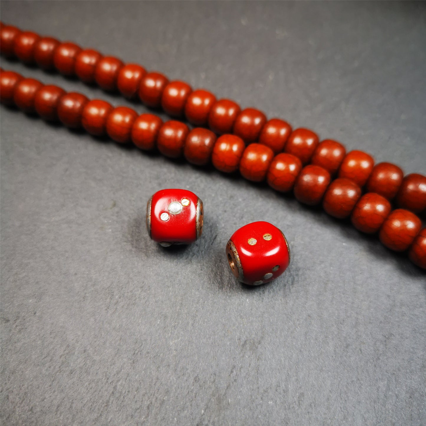 These marker beads were handmade by Tibetan craftsmen and come from Hepo Town, Baiyu County, the birthplace of the famous Tibetan handicrafts. It is made of plastic,inlaid cold iron,red color,size is 0.47" × 0.47". Fit for 8-12mm mala (The reference in the photo is 8mm mala)