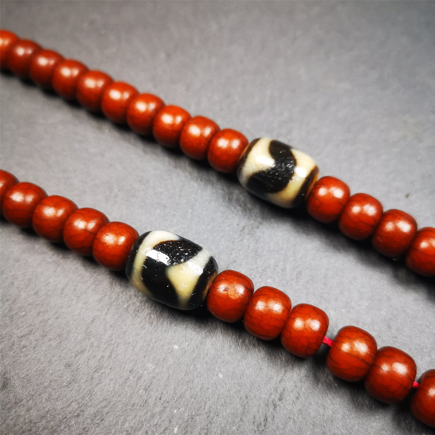 The list is a pair of tiger tooth dzi beads. These dzi beads were made in Tibet,can be used as marker beads for mala, or decorative beads on necklace or bracelet.