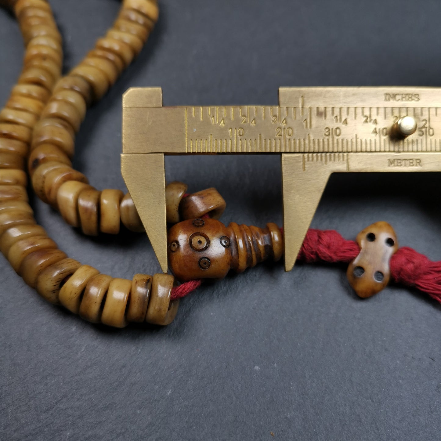 This unique wave shape mala was made by Tibetan craftsmen and come from Hepo Town, Baiyu County, the birthplace of the famous Tibetan handicrafts,about 30 years old. It is made of yak bone, yellow color,108 wave shape beads diameter of 10mm / 0.4",circumference is 48cm / 18.9", end of bone guru bead and vajra pendant. It reflects the original ascetic state of the original ecology, very simple and full of sense of time