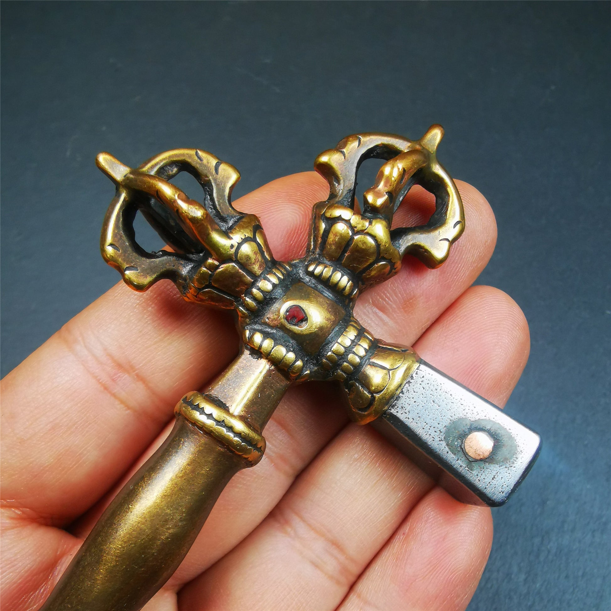 This vajra hammer was handmade by Tibetan craftsmen from Tibet in 1990's,from Hepo Town, Baiyu County, the birthplace of the famous Tibetan handicrafts. It is one ritual of dharma ritual implements,made of copper body and cold iron head.