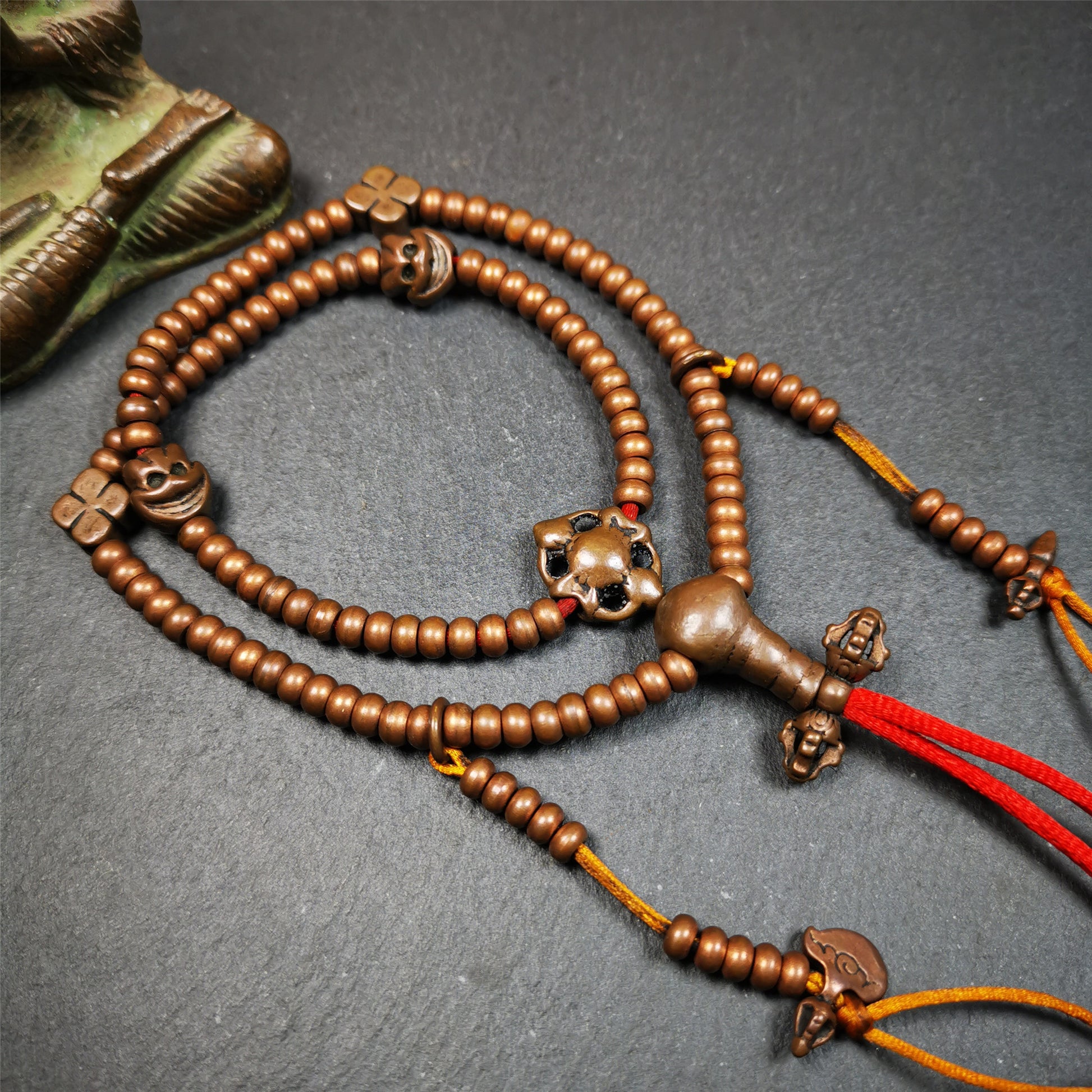 This mala was collect from Hepo Town Baiyu County Tibet, blessed in Yaqing Monastry. It is made of copper,brown color,length is 44cm / 18",has 1 Kartika ,2 skeletons, 2 stamp pendant, and 2 strings of counters with phurba + kartika.