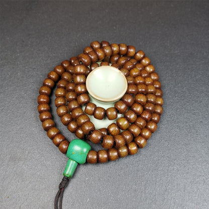 This mala was made by Tibetan craftsmen.  It is made of Corypha Linn Seeds, diameter of 10mm,0.4 inch,circumference is 80cm,32 inches , end of a turquoise guru bead.