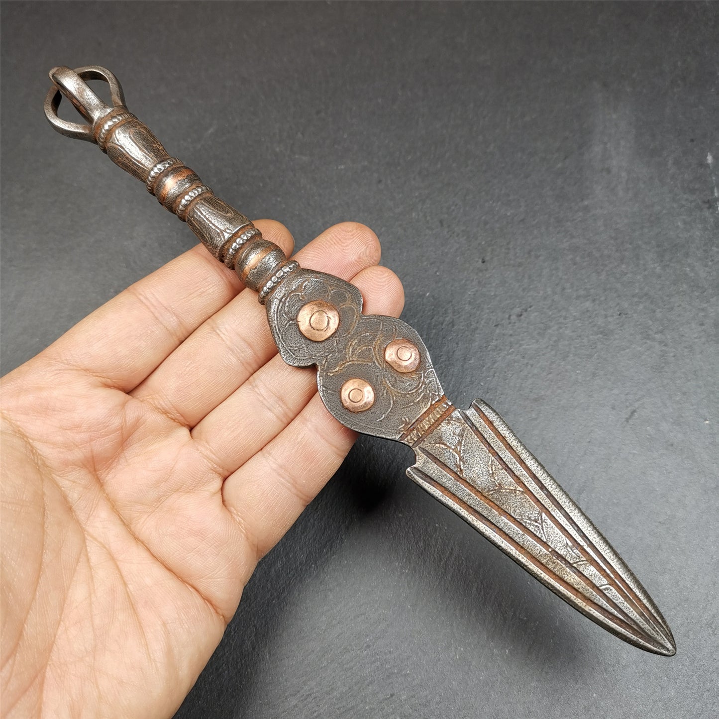 This phurba kila is handmade by Tibetan craftsmen from Tibet in 1990s.  It's a kila dagger, phurba,made of cold iron, carved cloud pattern, inlaid red copper, and the half vajra on the handle,8.7 inches length.