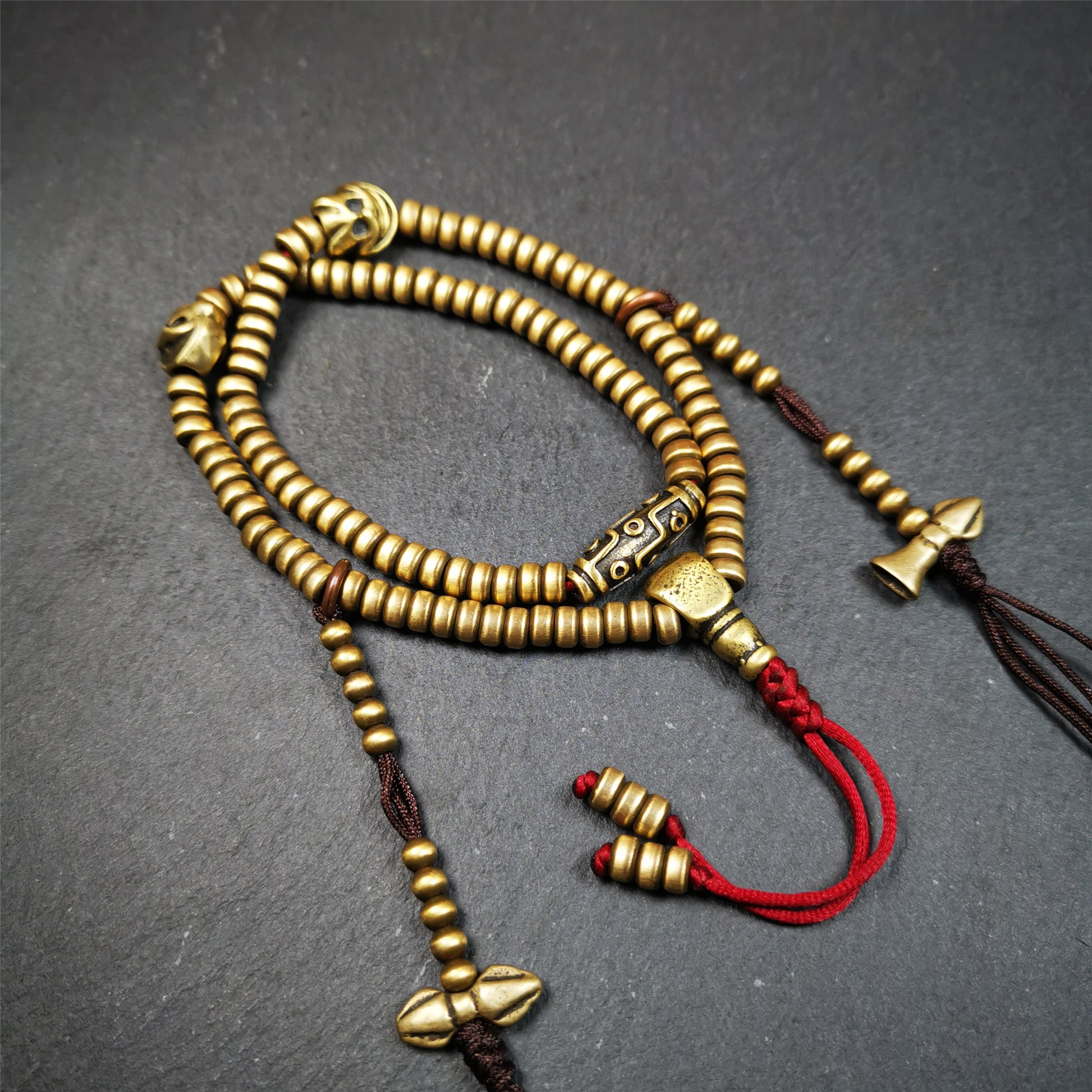 This mala was collect from Hepo Town Baiyu County Tibet 30 years ago, blessed in Yaqing Monastry. The necklace is made of lima brass, total 4 marker beads on it, and 1 set of bead counters ,very delicate and rare.