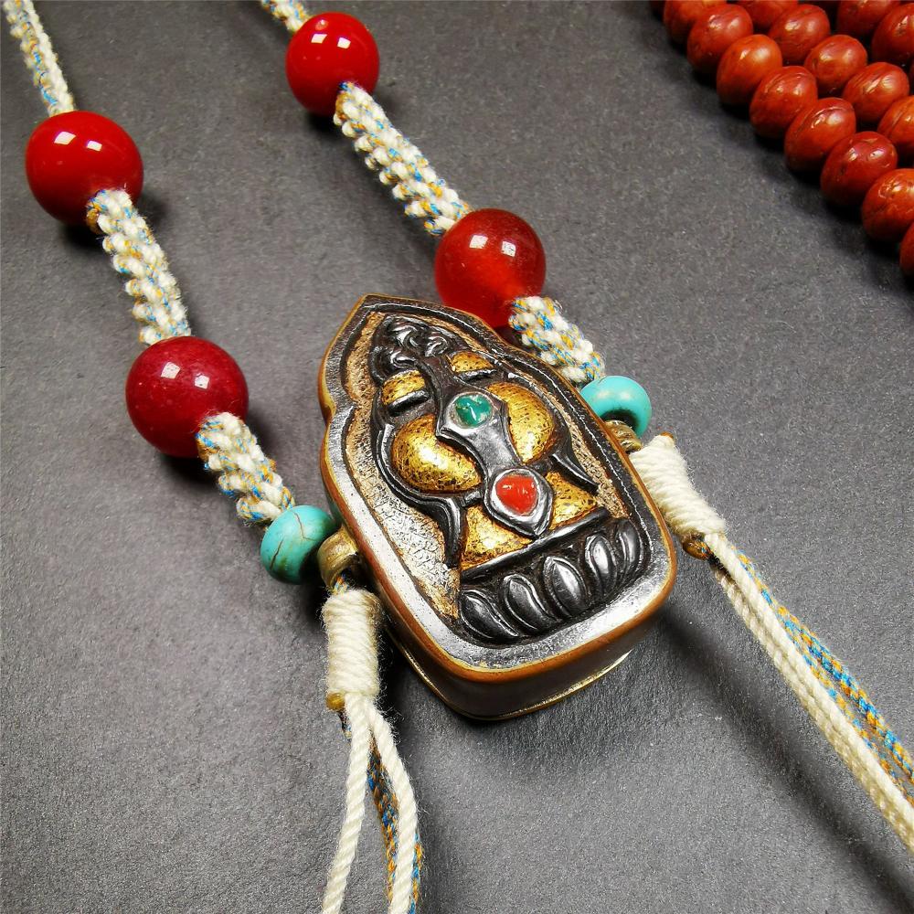 This portable Gau shrine was handcrafted by Tibetan artisans.  Its theme is mani jewel, a treasure vase on a lotus base, inside the vase are mani jewels and other jewels. Each exquisite pattern on it is meticulously hand-carved,and it is embellished with the technique of gold inlay, with cold iron and pure silver inlaid on the red copper material and gold-plated on the pure silver material,inlaid with turquoise and agate bead. 