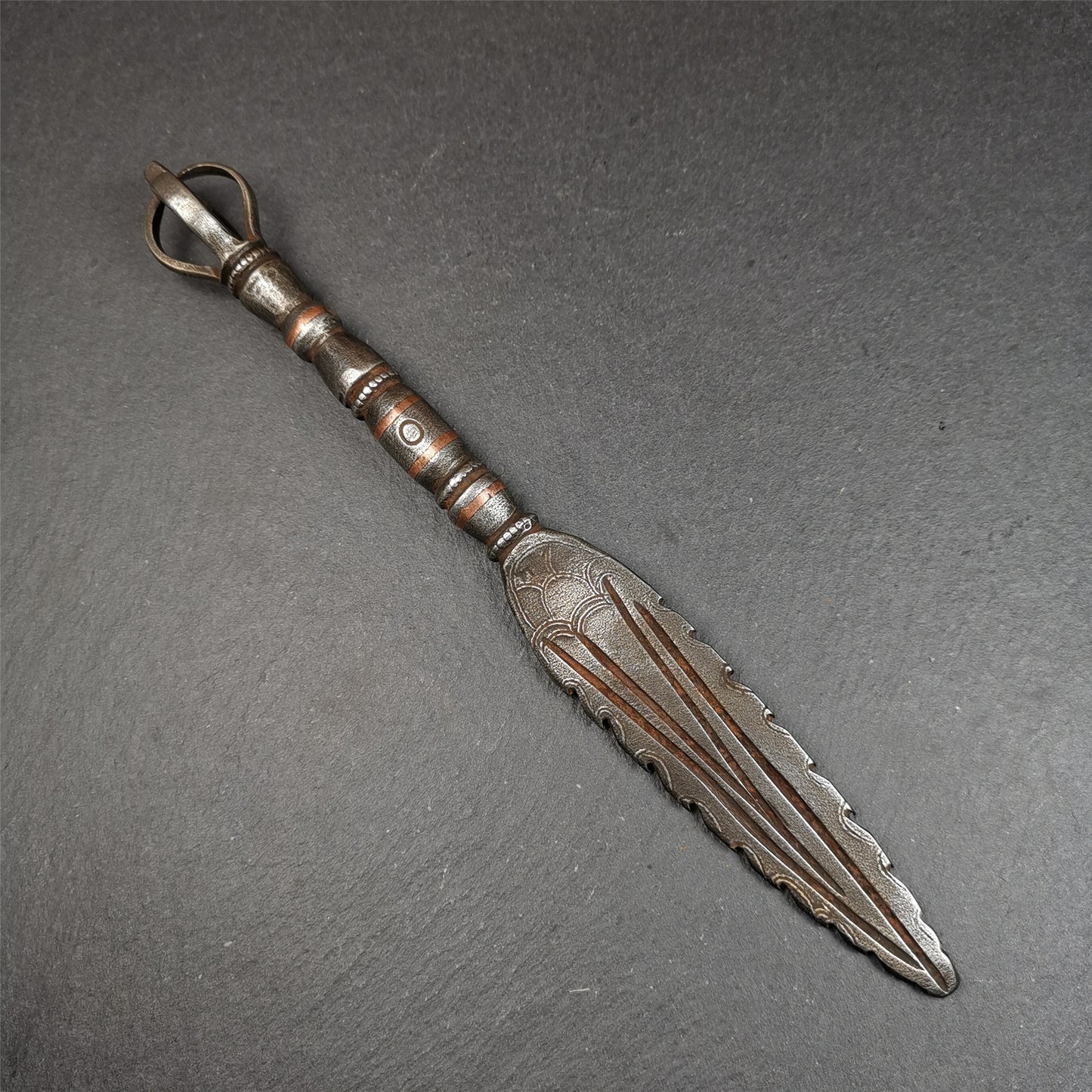 This vajra sword was handmade by Tibetan craftsmen from Tibet in 1990s. It's Fire Vajra Sword of Wisdom Buddha Manjushri,made of cold iron,inlaid red copper stripe,carved with flame pattern, and the half vajra at the tail,8.3 inches length.