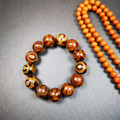  This 3 eyes bracelet was hand-woven by Tibetans,It's made of 3 eyes round dzi beads,brown color,diameter is 0.63", the circumference of bracelet is 7.5".  It can be worn not only as a fashionable accessory but also holds cultural and religious significance.